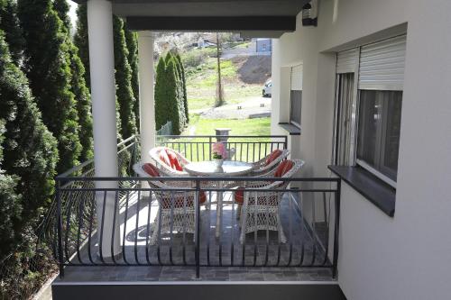a balcony with a table and chairs on a porch at Kuća JEKA in Vrnjačka Banja