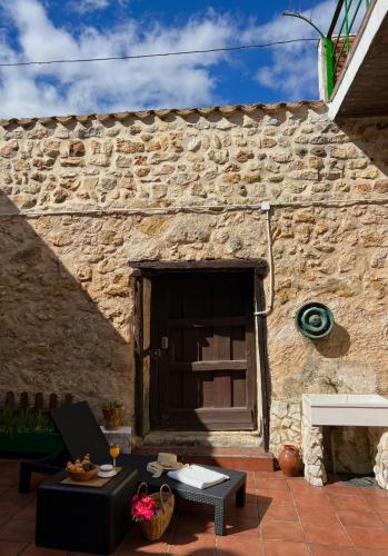 a stone building with a window and a patio at La Venta de Izan in Gumiel de Hizán