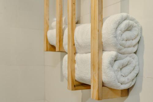 a pile of towels on a shelf in a bathroom at Kashco Apartments Wuse 2 Abuja in Abuja