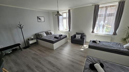 a living room with a couch and a chair at Penzion Grand Nymburk in Nymburk