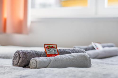 a pile of towels on top of a bed at Apartmány Rozárka Turnov in Turnov