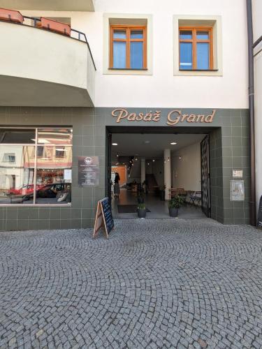 a store front with a sign in front of it at Penzion Grand Nymburk in Nymburk