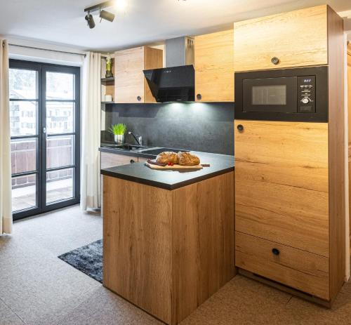 a kitchen with a counter with a plate of food on it at Schittlerhof in Fischen