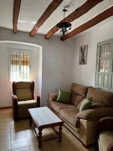 a living room with a couch and a coffee table at La Casilla in Montilla