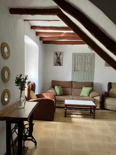 a living room with a couch and a table at La Casilla in Montilla