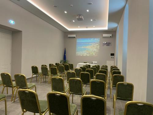a room with chairs and a table and a screen at Grand Hotel & des Anglais Spa in Sanremo