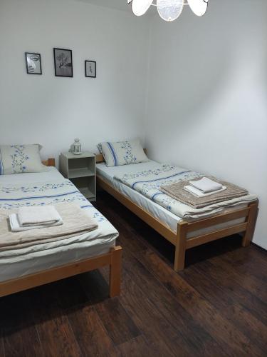 two beds sitting next to each other in a room at Holiday House in Zaječar