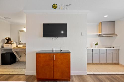 a kitchen with a flat screen tv on a wall at Gateway Lodge in Seaside
