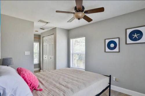 a bedroom with a bed and a ceiling fan at Summer Sands Lodge Unit 2 in Flagler Beach