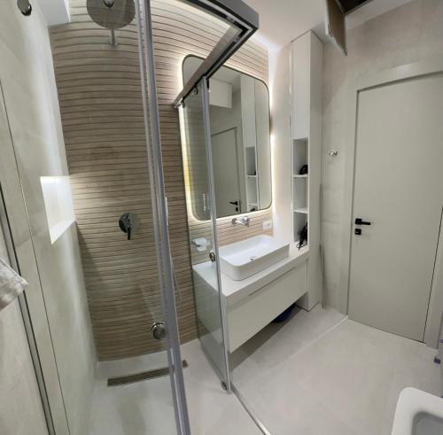 a bathroom with a sink and a shower at Sea Scape Apartment 3 in Vlorë