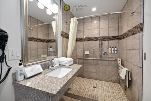 a bathroom with a sink and a shower at Gateway Lodge in Seaside