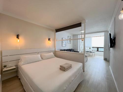 een slaapkamer met een groot wit bed en een eetkamer bij Xookoob Refugio de Arena in Patalavaca