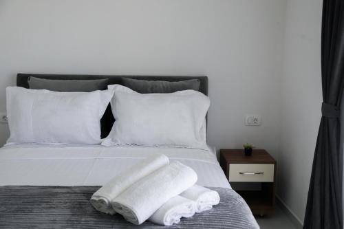 a bed with two towels on top of it at Villa Palace in Ulcinj