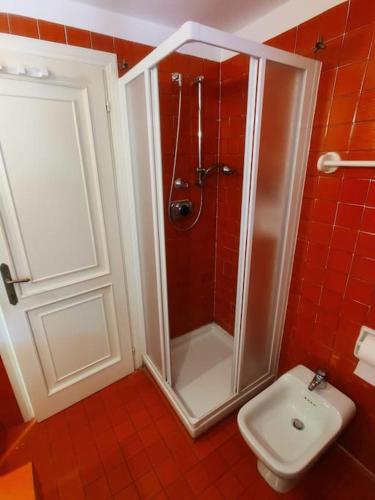 a bathroom with a shower and a toilet at Lara's Green Home in Quercianella