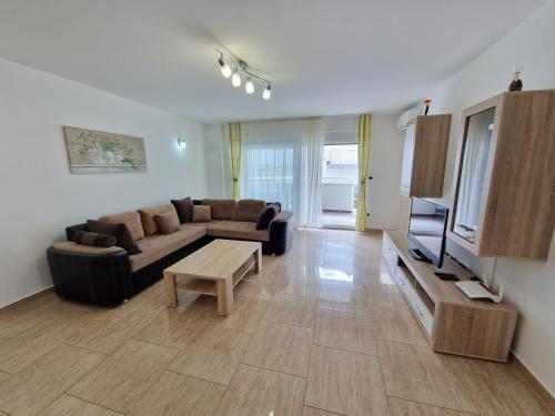 a living room with a couch and a table at Apartments Maslina in Baška