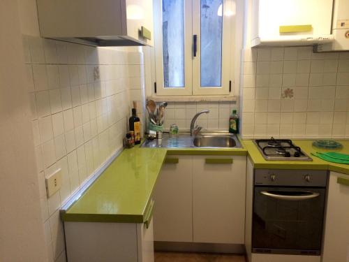 a kitchen with a green counter top and a sink at xx settembre House in the city with Garden in Perugia