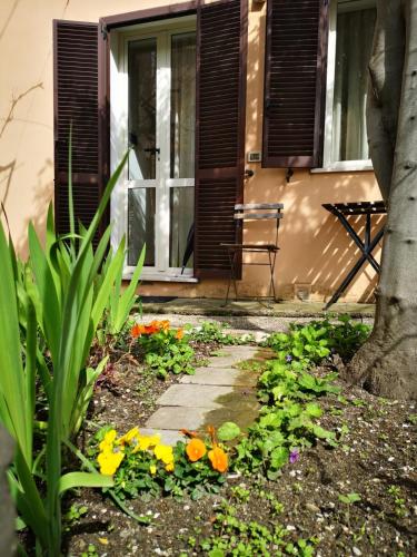 a garden with flowers in front of a house at xx settembre House in the city with Garden in Perugia