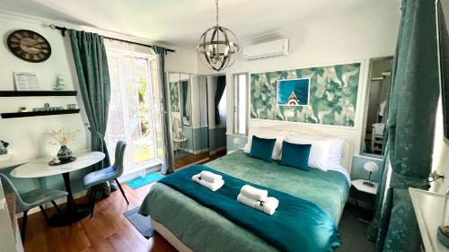 a bedroom with a green bed with towels on it at Marcel Zadar City Center in Zadar