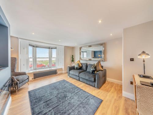 a living room with a couch and a table at Captain's Quarters in Seaton Carew