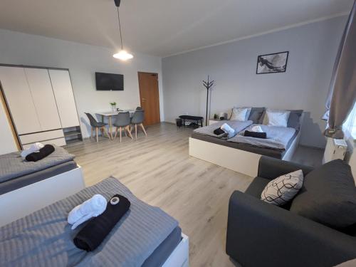 a living room with two couches and a table at Penzion Grand Nymburk in Nymburk