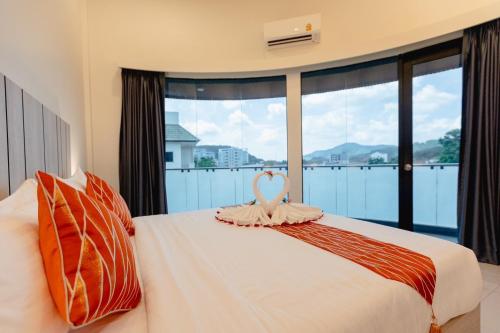 a bedroom with a bed with a heart on it at SUBANAN Residence - SHA Extra Plus Certified in Ban Kohong