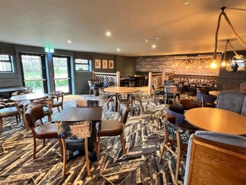 a bar with tables and chairs in a restaurant at Caravan near Port Carlisle in Aikton