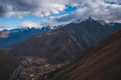 a view of a mountain range with snow capped mountains at Vertical Sky Suites in Ollantaytambo