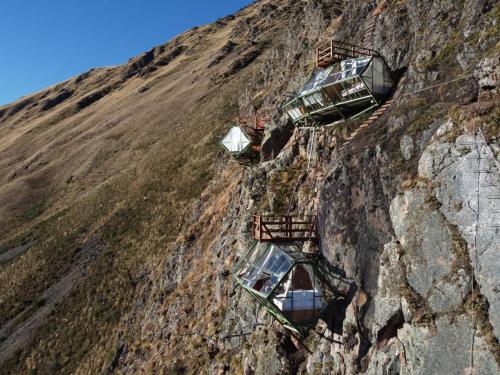 a group of cars on the side of a mountain at Vertical Sky Suites in Ollantaytambo