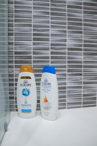 two bottles of milk sitting on a shelf at Genova Suite in Genova
