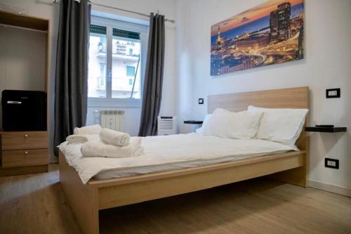 a bedroom with a bed with white sheets and pillows at Genova Suite in Genova