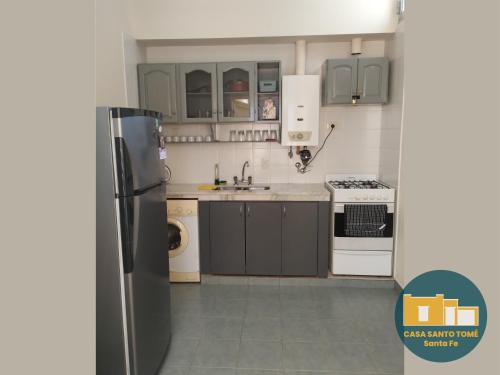 a kitchen with a refrigerator and a sink at Casa Santo Tomé in Santo Tomé