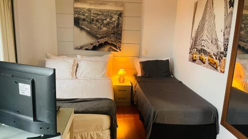 En eller flere senge i et værelse på Flat de Luxo Aeroporto Congonhas - Hotel eSuites