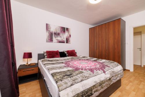 a bedroom with a large bed and a wooden cabinet at Apartmani Anđelić- Fužine 1 in Fužine