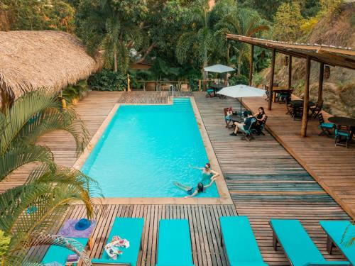 a pool at a resort with people swimming in it at Hotel Isabella Tayrona in Los Naranjos