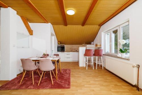 a kitchen and dining room with a table and chairs at Apartmani Anđelić- Fužine 1 in Fužine