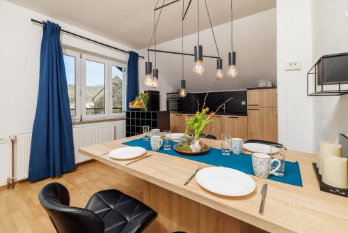 a dining room with a blue table and chairs at Apartmani Anđelić- Fužine 1 in Fužine