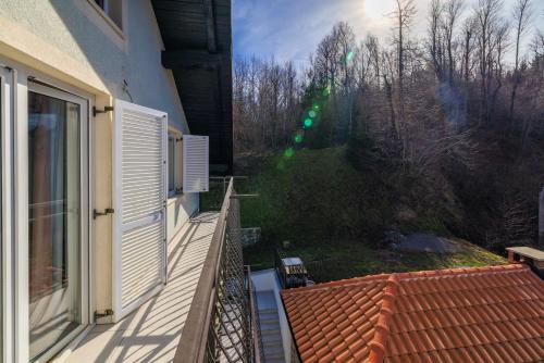 a balcony of a house with a view of a yard at Apartmani Anđelić- Fužine 1 in Fužine