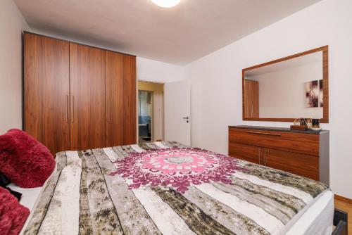 a bedroom with a large bed and a dresser at Apartmani Anđelić- Fužine 1 in Fužine