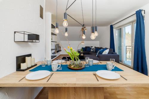 a dining room with a table with plates on it at Apartmani Anđelić- Fužine 1 in Fužine