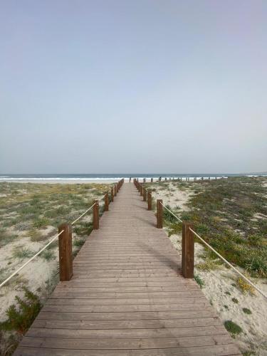 a wooden boardwalk leading to the beach at Sara Sole & Mare in Torpè