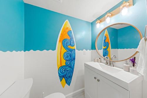 a bathroom with a surfboard mural on the wall at New Luxury Listing! Walking distance to shops, lake & beach in Destin