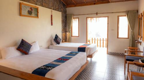 a hotel room with two beds and a window at Sapa Eco Homestay in Sa Pa