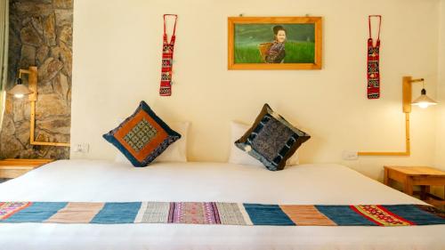 a bedroom with a bed with two pillows on it at Sapa Eco Homestay in Sa Pa