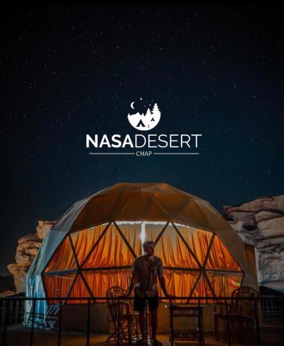 a man standing in front of a tent at Nasa desert luxury camp in Wadi Rum