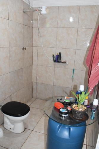 a bathroom with a shower with a toilet and a table at Hostel Cascavel in Cascavel