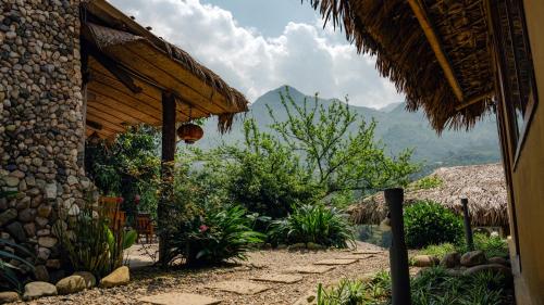 a stone building with a pathway leading to a house at Sapa Eco Homestay in Sa Pa