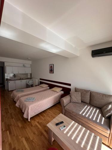 a living room with two beds and a couch at Apartments Nora in Ohrid