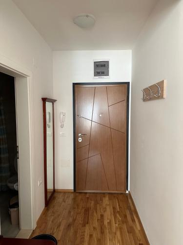 a large wooden door in a room with wooden floors at Apartments Nora in Ohrid