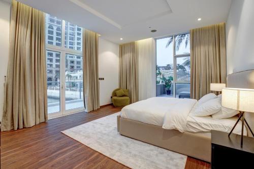 a bedroom with a large bed and a large window at Oceana Atlantic Seaside Apt in Dubai