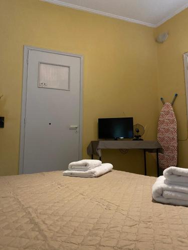 a bedroom with two white towels on a bed at Marina's house in Salamina